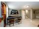 Finished basement bar area featuring a tv, two stools, mini fridge, and neutral paint at 2804 Dunnington Cir, Chamblee, GA 30341