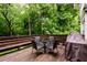 Inviting deck with table and chairs, ideal for outdoor entertaining and enjoying the wooded view at 2804 Dunnington Cir, Chamblee, GA 30341