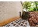 Exterior brick wall with stepping stone path leading to basement entrance and stairs at 2804 Dunnington Cir, Chamblee, GA 30341