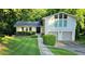 Charming two-story home with a well-manicured lawn, beautiful greenery, and a two car garage at 2804 Dunnington Cir, Chamblee, GA 30341