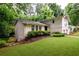 Charming two-story home with a well-manicured lawn and lush greenery, providing a serene and inviting atmosphere at 2804 Dunnington Cir, Chamblee, GA 30341