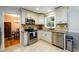 Modern kitchen with stainless steel appliances, granite countertops, and a view into the adjacent dining area at 2804 Dunnington Cir, Chamblee, GA 30341