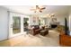 Cozy living room featuring a fireplace, ceiling fans, and access to the outdoor deck at 2804 Dunnington Cir, Chamblee, GA 30341