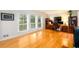 Bright living room with hardwood floors, built-in bookshelves, a workspace, and ample natural light from large windows at 2804 Dunnington Cir, Chamblee, GA 30341