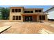 Unfinished home with two-stories, an open back porch, and numerous window openings on a construction site at 452 Maypop Lane, Woodstock, GA 30188