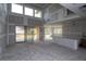 Unfinished living room with soaring ceilings and sliding glass doors, providing a blank canvas for customization at 452 Maypop Ln, Woodstock, GA 30188