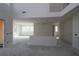 Spacious living room featuring high ceilings, large windows, and an open layout, ready for customization at 452 Maypop Ln, Woodstock, GA 30188