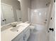 Bright bathroom featuring white fixtures, a vanity with a quartz countertop, and a shower/tub combination at 5704 Urban Village Way # 3, Tucker, GA 30084