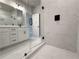 Modern bathroom featuring a glass enclosed shower with marble-style tile, white cabinetry, and black fixtures at 5704 Urban Village Way # 3, Tucker, GA 30084