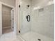 Modern bathroom featuring a glass enclosed shower with marble-style tile and view into closet space at 5704 Urban Village Way # 3, Tucker, GA 30084