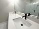 Modern bathroom featuring double sinks with black fixtures and a mirrored wall at 5704 Urban Village Way # 3, Tucker, GA 30084