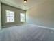 Neutral carpeted bedroom with two windows that provide plenty of natural light and a glimpse of the outdoors at 5704 Urban Village Way # 3, Tucker, GA 30084
