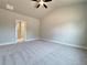 Bright bedroom featuring plush carpeting, neutral walls, a large window, and access door at 5704 Urban Village Way # 3, Tucker, GA 30084