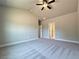 Bright bedroom featuring plush carpeting, neutral walls, a large window, and access door at 5704 Urban Village Way # 3, Tucker, GA 30084