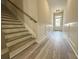 Inviting foyer featuring hardwood floors, staircase with wood railings, and a glass-paneled front door at 5704 Urban Village Way # 3, Tucker, GA 30084