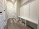 Hallway with a built-in bench and storage, next to multiple doors and light colored walls at 5704 Urban Village Way # 3, Tucker, GA 30084