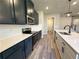 Bright kitchen featuring dark cabinets, stainless steel appliances, white countertops, and modern pendant lighting at 5704 Urban Village Way # 3, Tucker, GA 30084