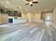 Stylish living area featuring hardwood floors, modern light fixtures, and an open connection to the kitchen at 5704 Urban Village Way # 3, Tucker, GA 30084