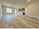 Open-concept living area with hardwood floors, a modern kitchen, and a view of the backyard at 5704 Urban Village Way # 3, Tucker, GA 30084