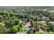 Community aerial view showcases lush trees, tennis courts, and residential buildings within a serene landscape at 82 Twiggs Cor, Peachtree City, GA 30269