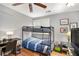 A bedroom with gray walls, a bunk bed, a ceiling fan, and laminate flooring at 82 Twiggs Cor, Peachtree City, GA 30269
