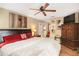 Comfortable bedroom featuring a ceiling fan, a painting above the headboard, and an armoire at 82 Twiggs Cor, Peachtree City, GA 30269