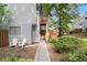 Inviting townhome featuring a quaint front entrance, private outdoor space, and mature landscaping at 82 Twiggs Cor, Peachtree City, GA 30269