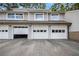 View of the three garages featuring white doors that complement the neutral siding of the townhome building at 82 Twiggs Cor, Peachtree City, GA 30269