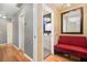Hallway view towards a bathroom with a vanity and a red sofa on the side at 82 Twiggs Cor, Peachtree City, GA 30269