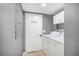 Functional laundry room equipped with washer, dryer, and overhead storage cabinets at 82 Twiggs Cor, Peachtree City, GA 30269