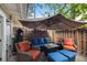 Outdoor patio area with comfortable seating and a large umbrella at 82 Twiggs Cor, Peachtree City, GA 30269