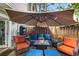 Cozy patio area featuring comfortable seating beneath a large umbrella, perfect for outdoor relaxation and entertaining at 82 Twiggs Cor, Peachtree City, GA 30269