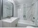 Well-lit bathroom with marble tile, a shower-tub combo, and modern fixtures, offering a clean and stylish space at 106 Adair Ave, Atlanta, GA 30315