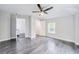 Bright bedroom featuring grey wood floors, ample lighting, and access to an ensuite bathroom at 106 Adair Ave, Atlanta, GA 30315
