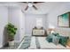 Staged bedroom featuring vibrant artwork, stylish dresser, and lush greenery, creating a comfortable and inviting space at 106 Adair Ave, Atlanta, GA 30315
