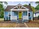 Charming blue home featuring a welcoming front porch and bright yellow door at 106 Adair Ave, Atlanta, GA 30315