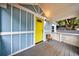 Inviting covered front porch with blue siding, white trim, and a bright yellow door at 106 Adair Ave, Atlanta, GA 30315