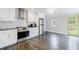 Modern kitchen features stainless steel appliances, white cabinets, and dark countertops at 106 Adair Ave, Atlanta, GA 30315