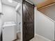 Laundry room featuring white washer and grey rustic barn door at 106 Adair Ave, Atlanta, GA 30315