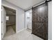 Bright laundry room featuring a sliding barn door, washer, and storage shelf, providing functionality and style at 106 Adair Ave, Atlanta, GA 30315