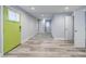 Bright living room with a distinctive green door, neutral walls, and hard surface floors, creating a modern and welcoming space at 106 Adair Ave, Atlanta, GA 30315