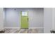 Bright living room with a striking door, neutral walls, and hardwood floors, creating a welcoming and modern space at 106 Adair Ave, Atlanta, GA 30315