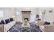 Bright living room with fireplace, hardwood floors, neutral furniture, and pops of blue at 106 Adair Ave, Atlanta, GA 30315