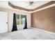 Spacious carpeted bedroom with tray ceiling and bright window at 2555 Flat Shoals Rd # 801, Atlanta, GA 30349
