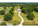 Expansive estate with a brick home, winding driveway, and lush green lawn in a serene, wooded setting at 3030 Berry Rd, Loganville, GA 30052