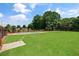 Expansive backyard featuring lush green grass, an outdoor shower, and mature trees at 3030 Berry Rd, Loganville, GA 30052