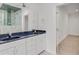 Bright bathroom featuring marble accent tile in the shower and a white double vanity at 3030 Berry Rd, Loganville, GA 30052