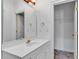 Stylish bathroom featuring a white vanity with gold fixtures and a large mirror at 3030 Berry Rd, Loganville, GA 30052