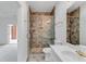Nicely tiled bathroom featuring an open walk-in shower with seamless glass and gold fixtures at 3030 Berry Rd, Loganville, GA 30052