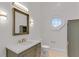 Charming bathroom featuring stylish vanity with octagon window for natural light at 3030 Berry Rd, Loganville, GA 30052